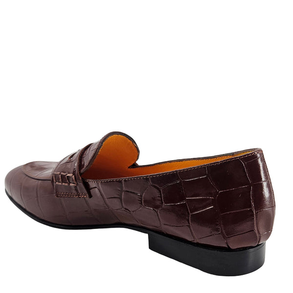 Brown crocodile-patterned loafer shoe on a white background