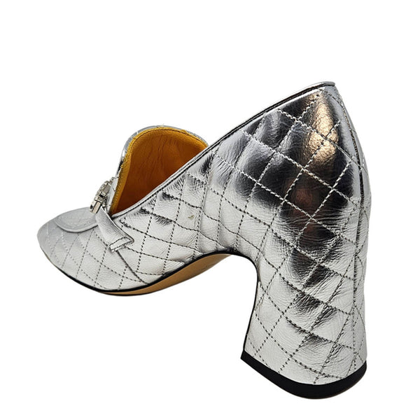 Silver quilted shoe with a block heel on a white background