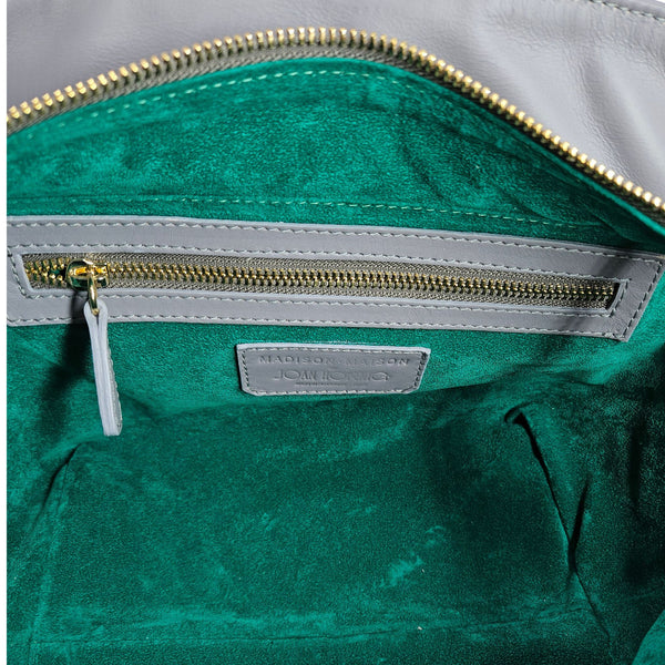 Green bag with gold zipper and visible brand label