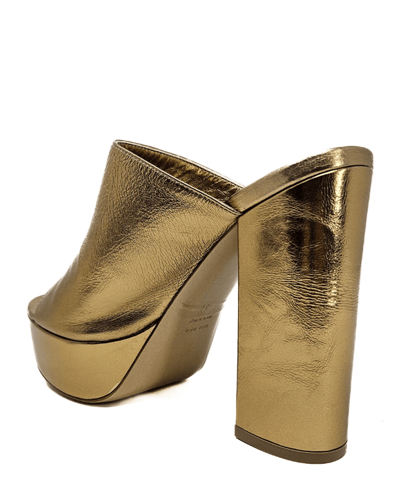 Open-toe platform mule with high block heel and wide upper strap. Features a smooth, metallic-textured finish and slip-on design for elevated wear.
