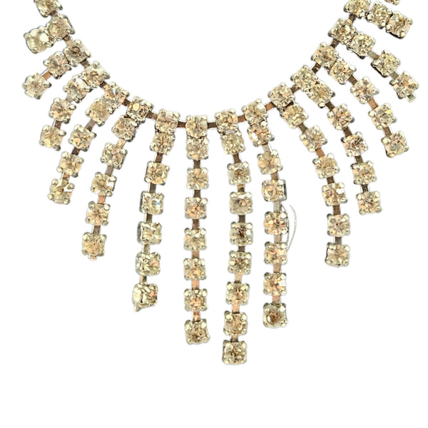 Gold necklace with crystal-like beads on a white background