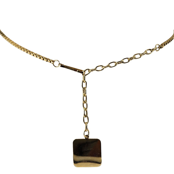 Gold necklace with a square pendant on a white background