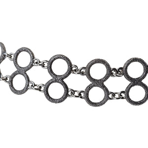 Silver chain necklace with interlocking circular links on a white background