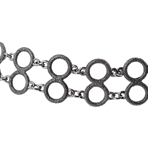 Silver chain necklace with interlocking circular links on a white background