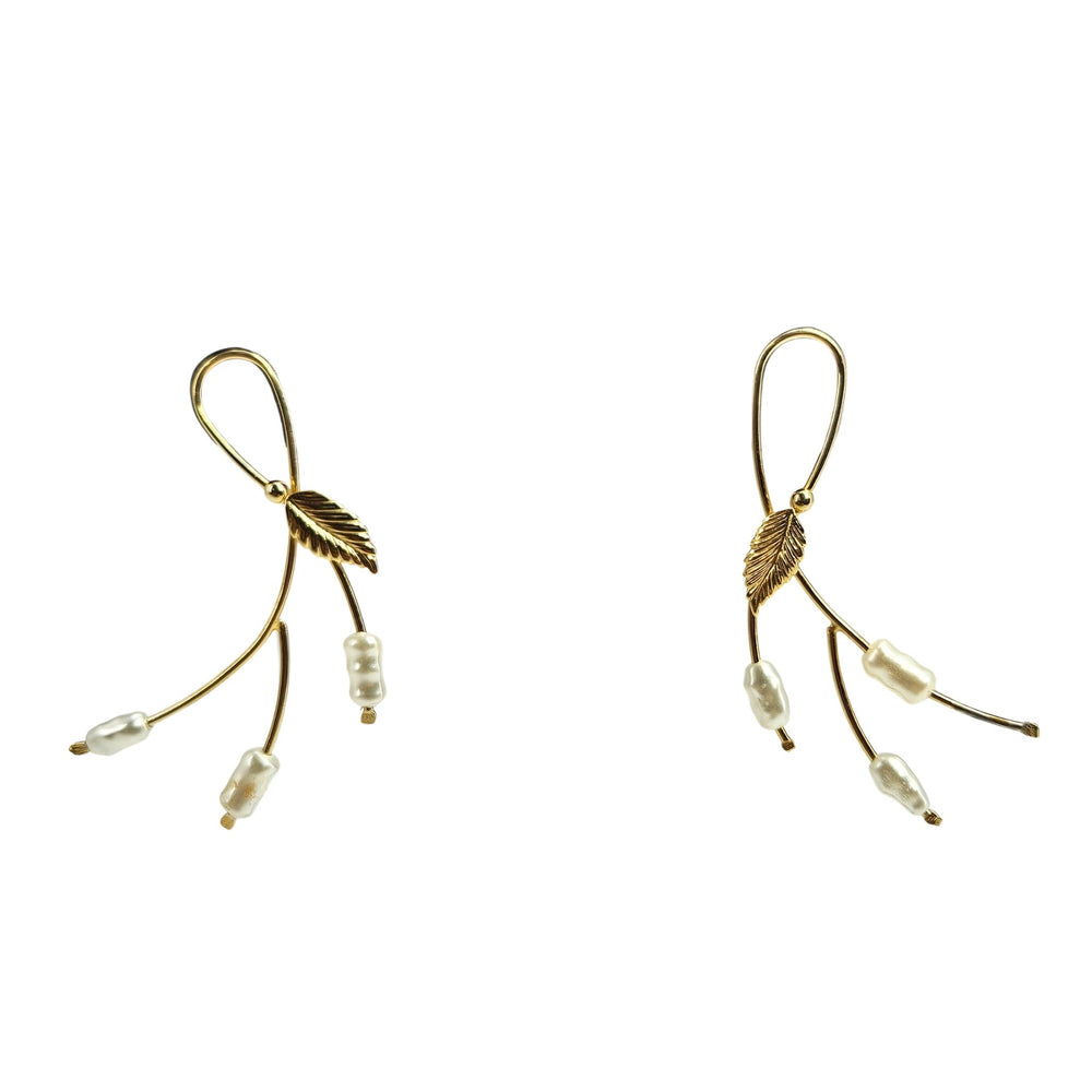 Gold leaf-shaped earrings with beads on a white background