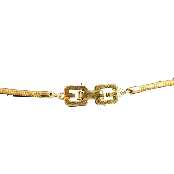Gold bracelet with a clasp on a white background