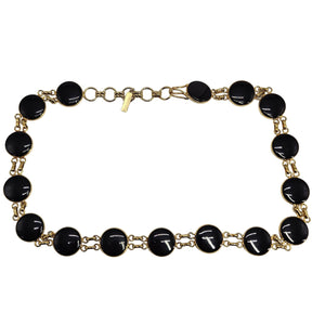 Black beaded necklace with gold chain on a white background