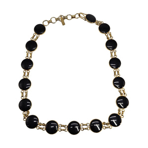 Necklace with black beads and gold chain on a white background