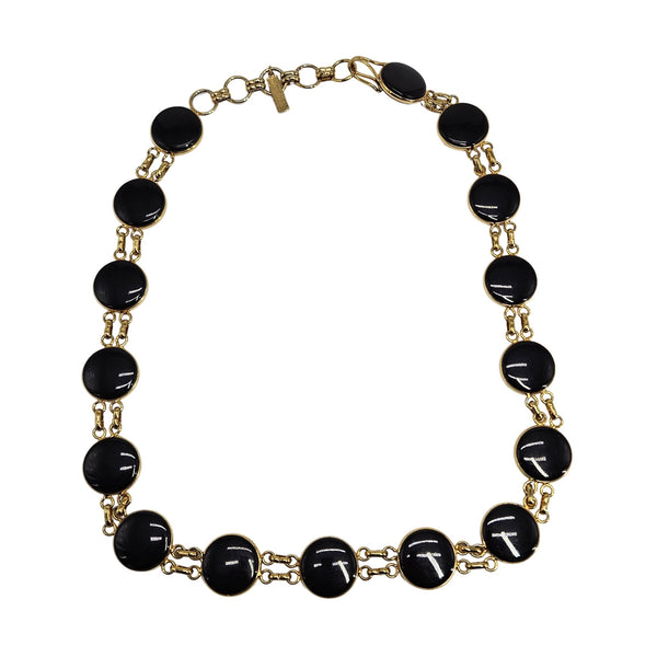 Necklace with black beads and gold chain on a white background