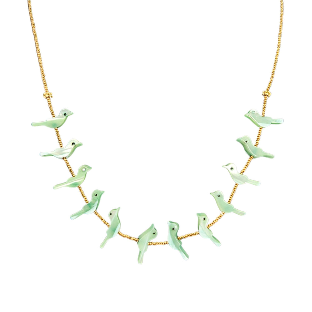 Necklace with green bird pendants on a gold chain against a white background