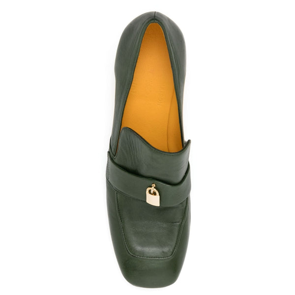 Green loafer shoe with gold buckle on a white background