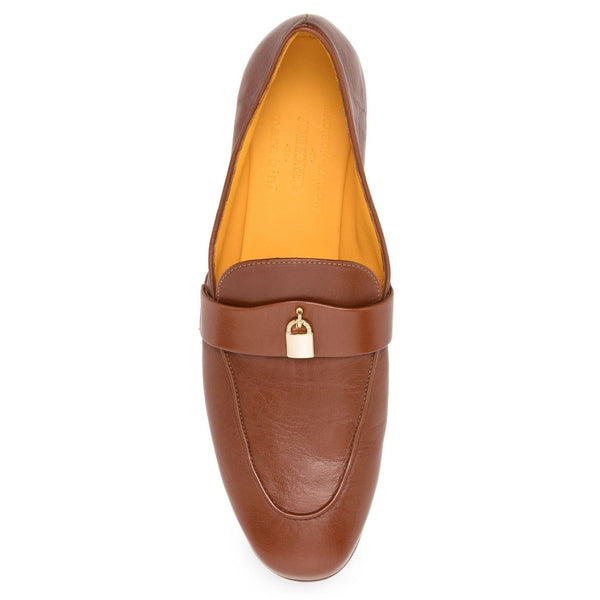 Brown leather loafer with gold buckle on a white background