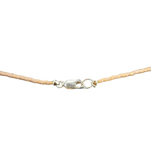 Beige cord with a silver clasp on a white background