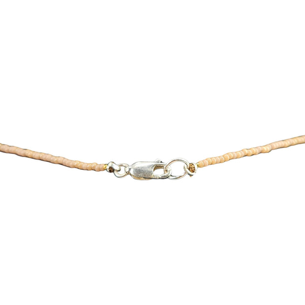 Beige cord with a silver clasp on a white background