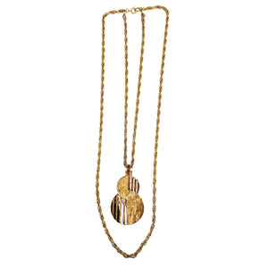 Gold necklace with a unique pendant on a white background