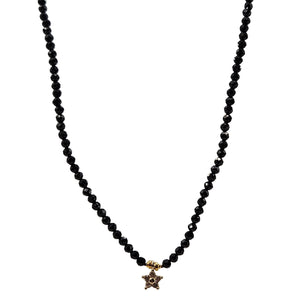 Black beaded necklace with a star-shaped pendant on a white background