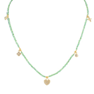 Necklace with green beads and gold pendants on a white background