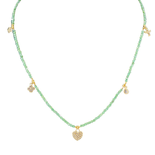 Necklace with green beads and gold pendants on a white background