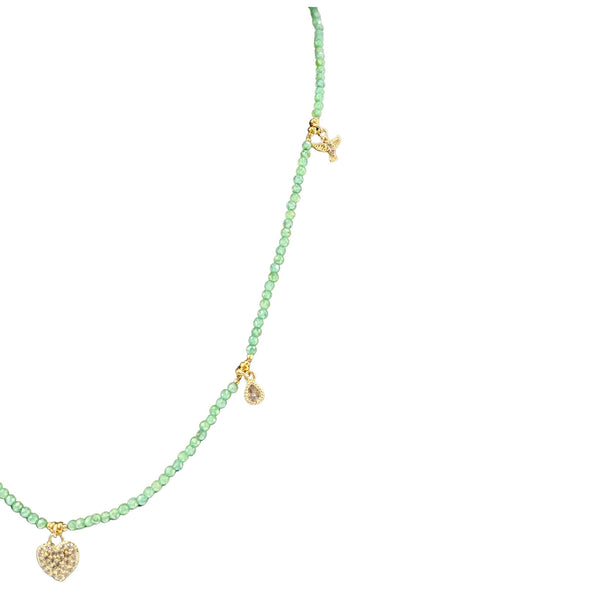 Green beaded necklace with gold heart pendants on a white background
