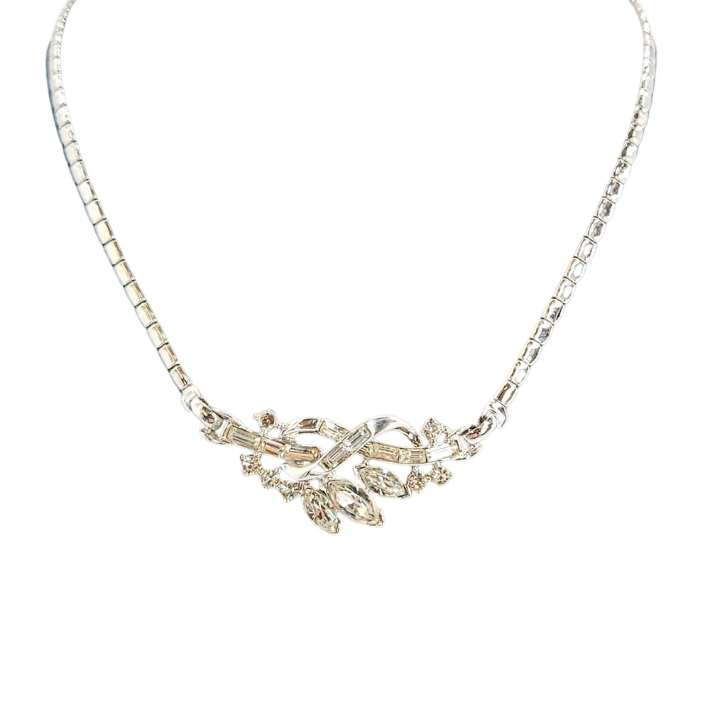 Silver necklace with floral pendant on a white background