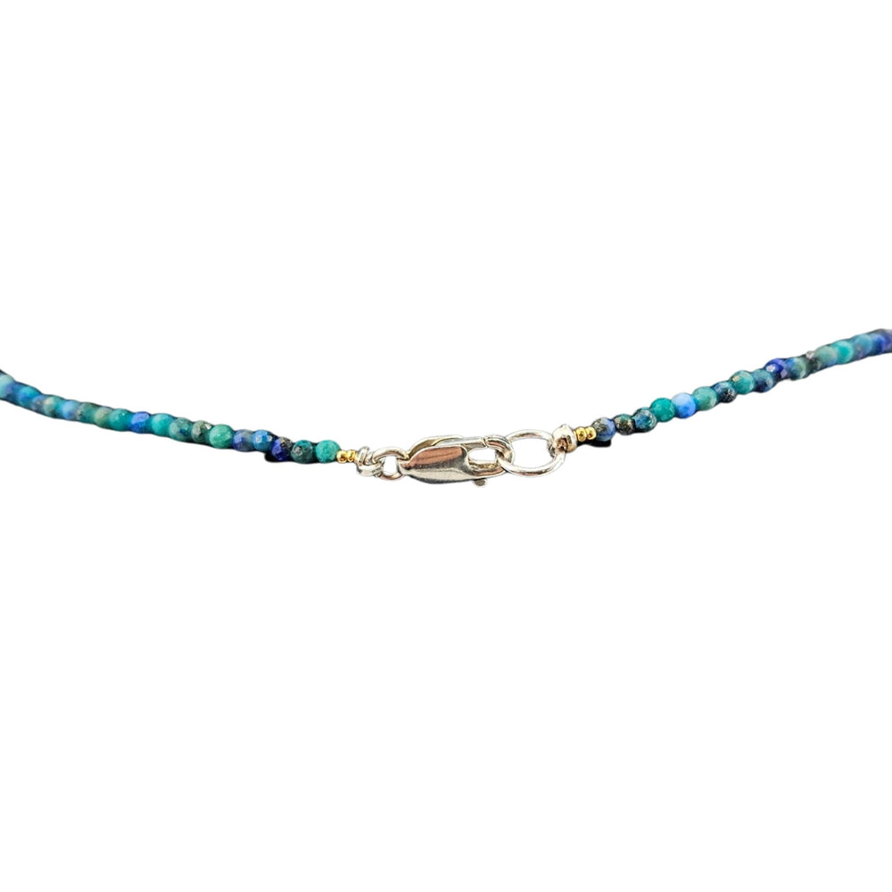 Blue and green beaded choker necklace with small gold charm and blue teardrop pendant