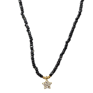 Black beaded necklace with a star-shaped pendant on a white background