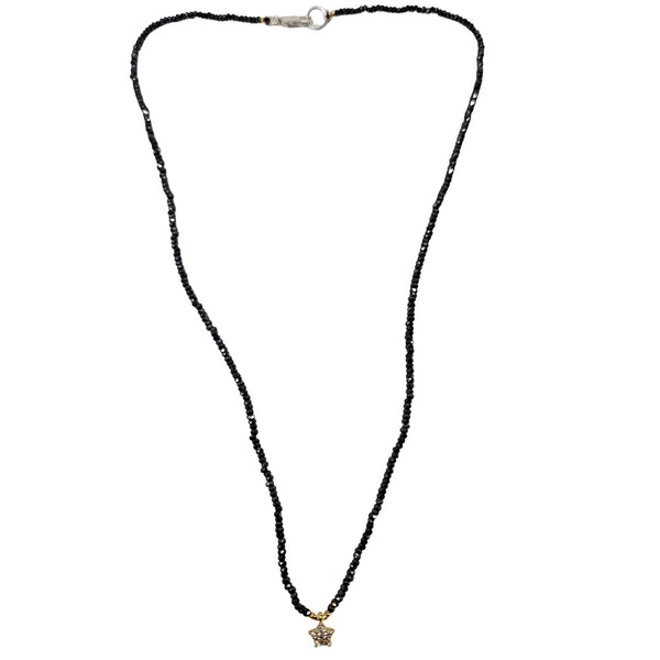 Black beaded necklace with a star pendant on a white background