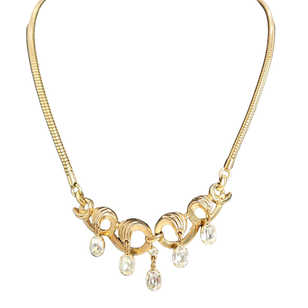 Gold necklace with pearl-like droplets on a white background
