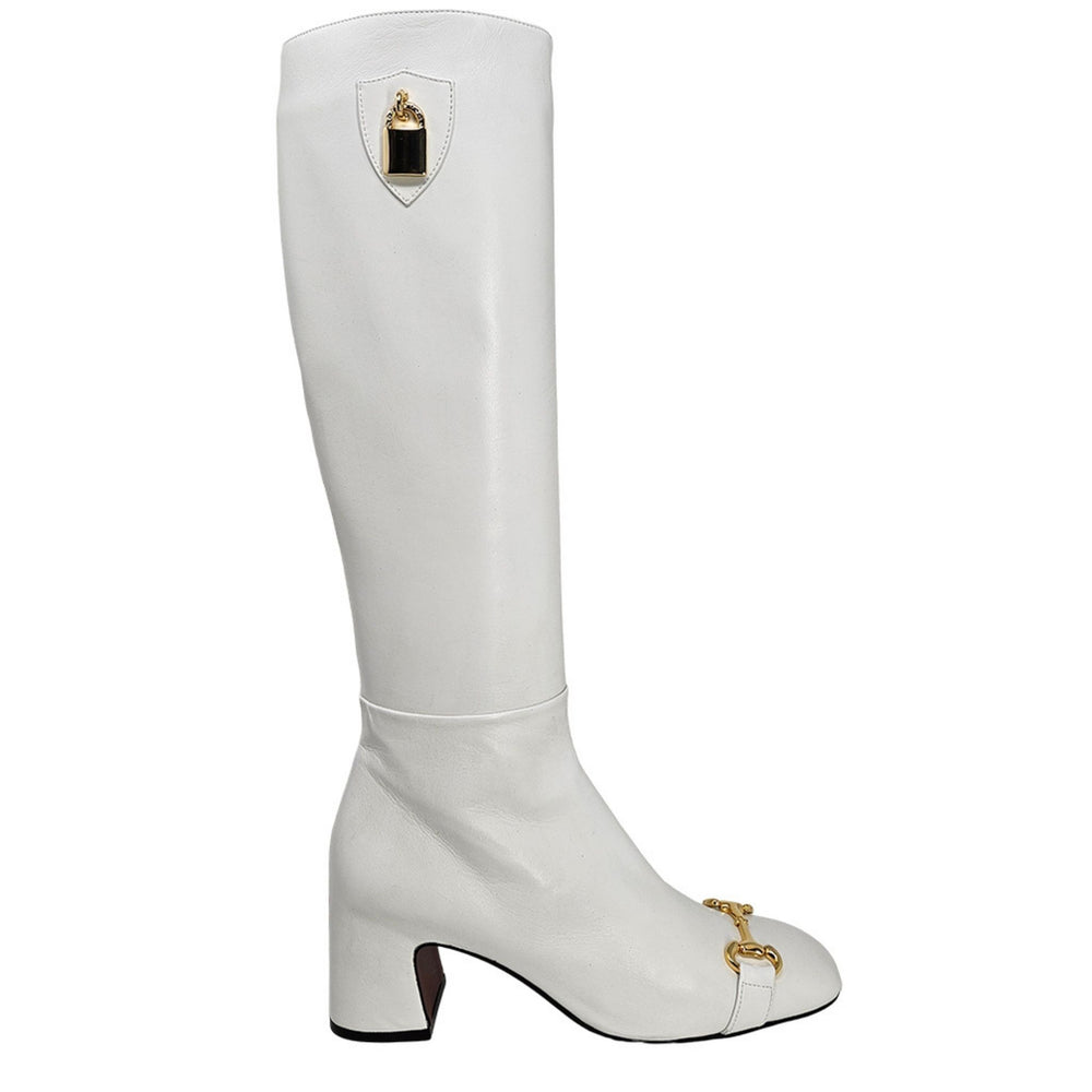 White knee-high boot with gold accents on a white background