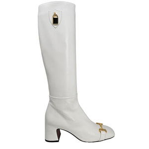 White knee-high boot with gold accents on a white background