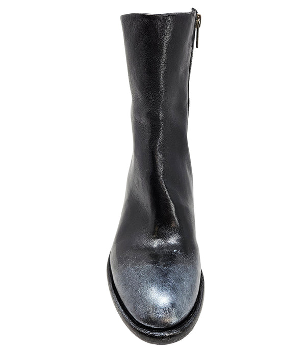 Mid-heel ankle boot crafted from premium leather with a softly rounded toe, artisanal distressed detailing at the toe and heel, and a stacked block heel. Features a full side zipper for easy entry, a leather-lined interior for comfort, and a durable leath