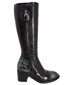 Tall leather boot featuring a softly rounded toe, mid-height stacked block heel, full side zipper for easy on and off, and a decorative metal lock accent near the top shaft. Crafted from premium leather with artisanal distressed detailing at the toe and h