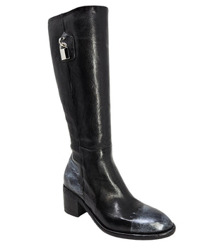 Tall leather boot featuring a softly rounded toe, mid-height stacked block heel, full side zipper for easy on and off, and a decorative metal lock accent near the top shaft. Crafted from premium leather with artisanal distressed detailing at the toe and h
