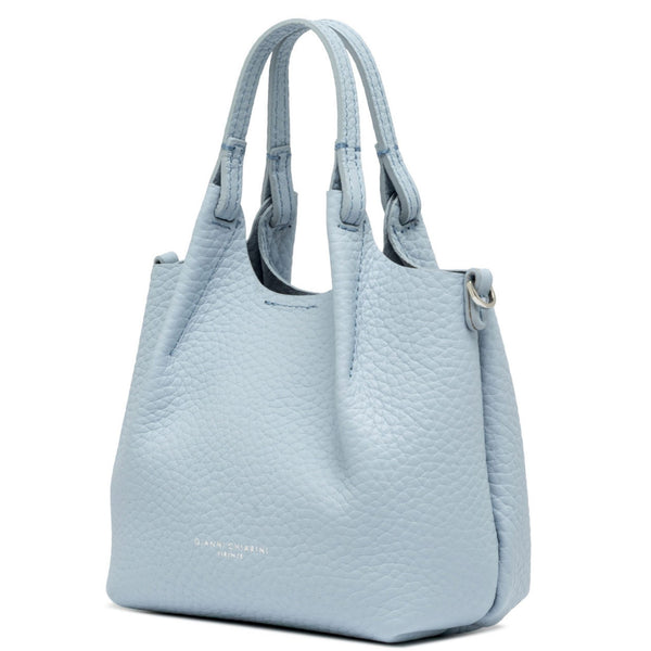 Light blue handbag with quilted texture on a white background