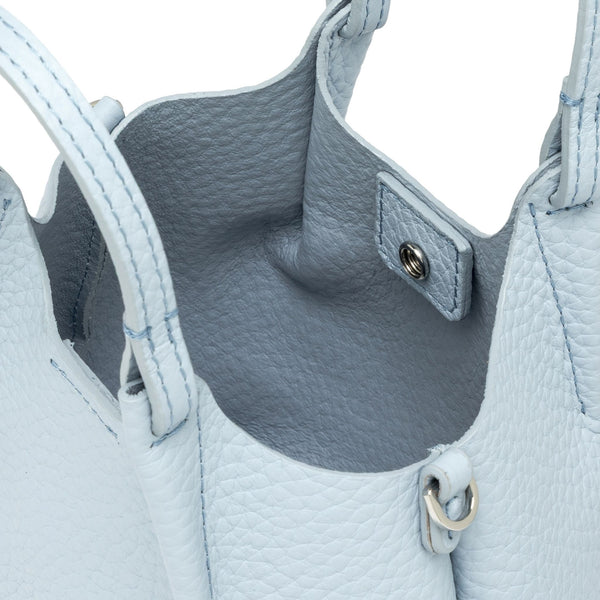 Close-up of a light blue leather handbag with visible stitching and hardware.