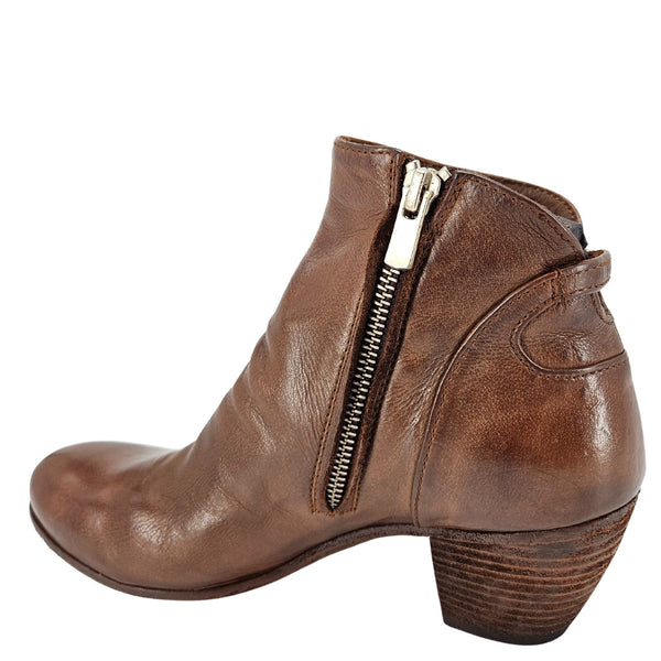 Brown leather ankle boot with a gold zipper on a white background