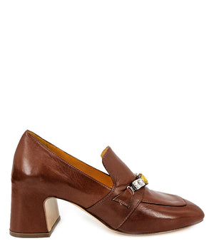 A leather heeled loafer with a block heel and square toe, featuring a decorative band with faceted gemstone-style embellishments across the upper. Designed by Madison in Beverly Hills and handcrafted in Italy.