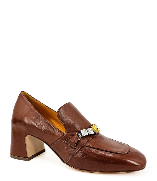 A leather heeled loafer with a block heel and square toe, featuring a decorative band with faceted gemstone-style embellishments across the upper. Designed by Madison in Beverly Hills and handcrafted in Italy.