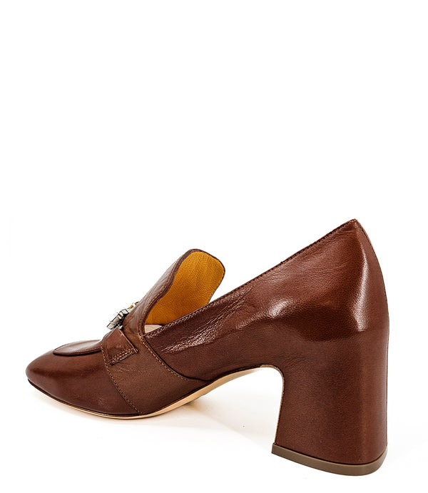 A leather heeled loafer with a block heel and square toe, featuring a decorative band with faceted gemstone-style embellishments across the upper. Designed by Madison in Beverly Hills and handcrafted in Italy.