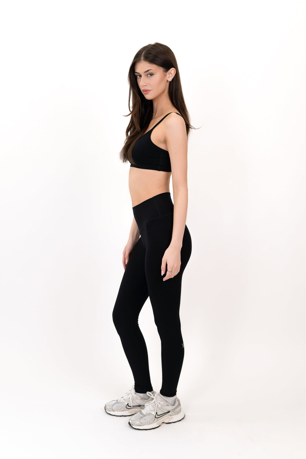 Black high-waist leggings with smooth stretch fit, full length.
