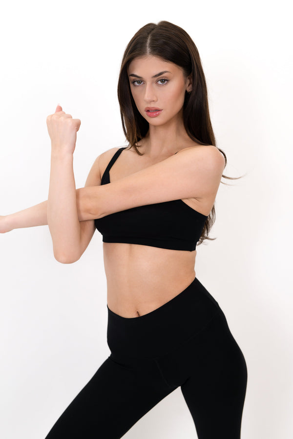 Model wearing The Form Bra in Onyx by ON/OFF Essentials, made from 95% bamboo.