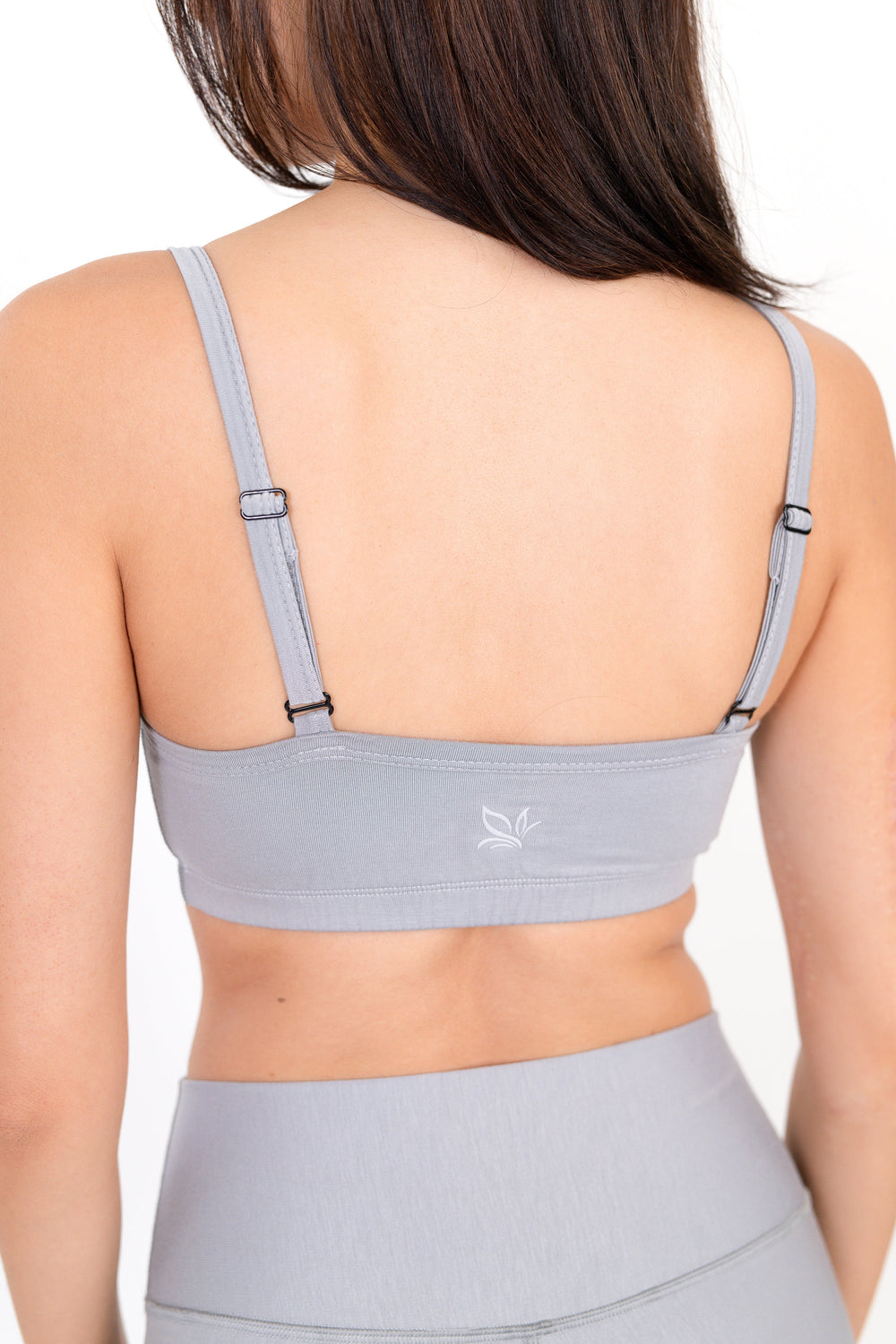 Gray sports bra with thin straps and scoop neckline, front view