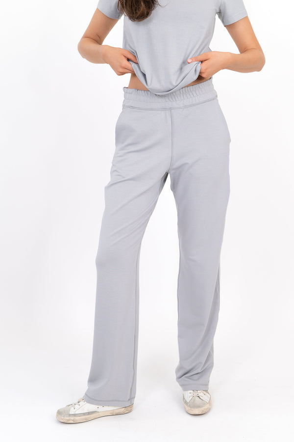 Model wearing The Solace Wide Leg Sweatpant in Fog by ON/OFF Essentials, made from 95% bamboo fleece.
