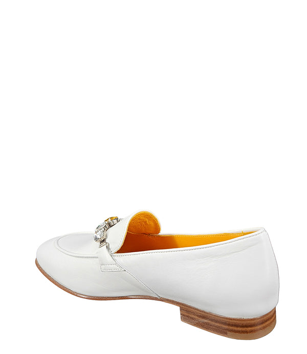 A leather loafer with a low stacked heel and rounded toe, featuring a decorative band adorned with faceted gemstone-style embellishments across the upper. Designed by Madison in Beverly Hills and handcrafted in Italy