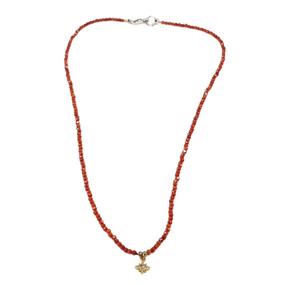 Orange faceted beaded necklace with gold-tone star pendant at center