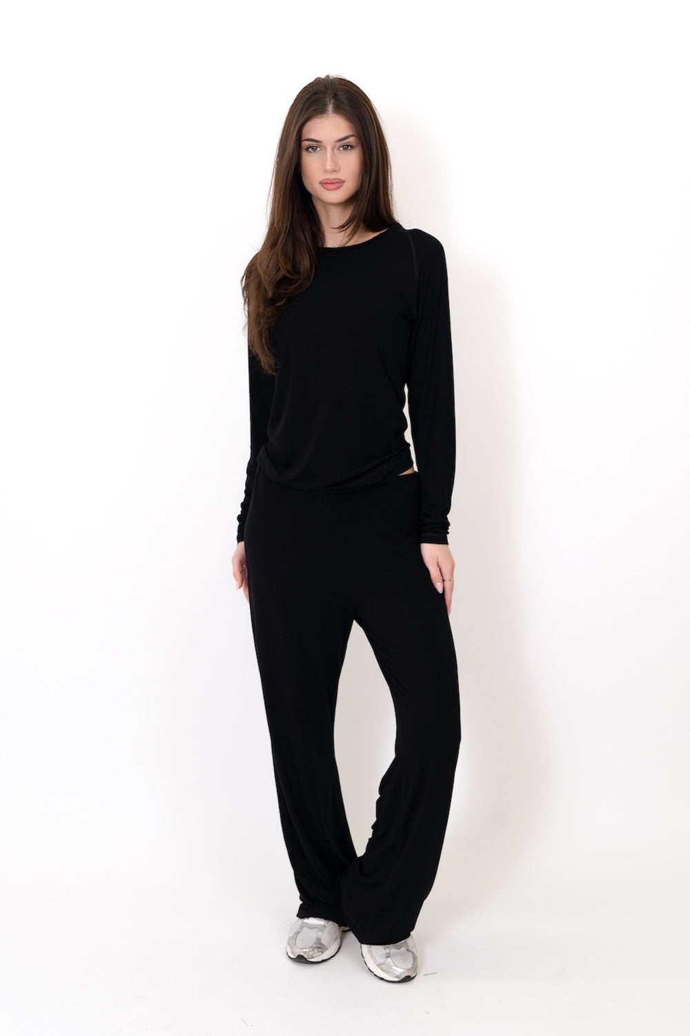 Woman wearing a black outfit on a white background