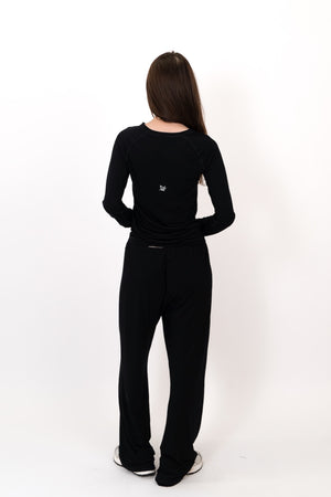 Person wearing a black outfit on a white background