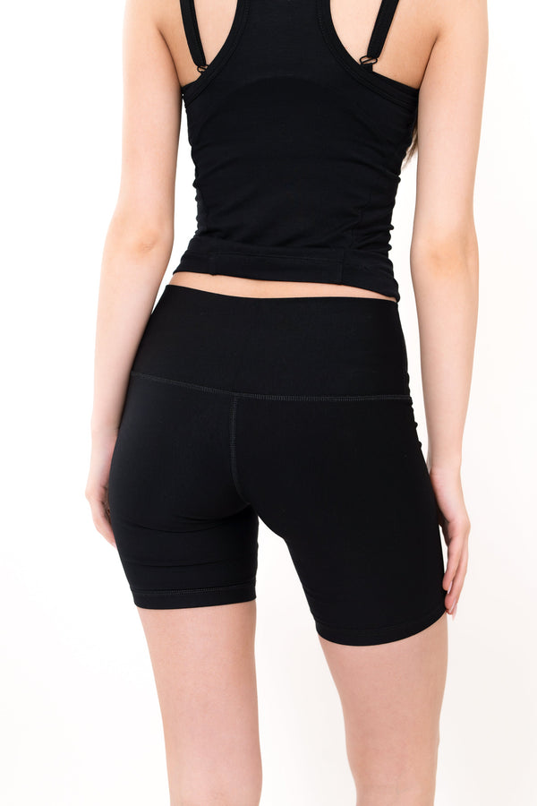 Model wearing The Core Short 5” in Onyx by ON/OFF Essentials, made from 95% bamboo.
