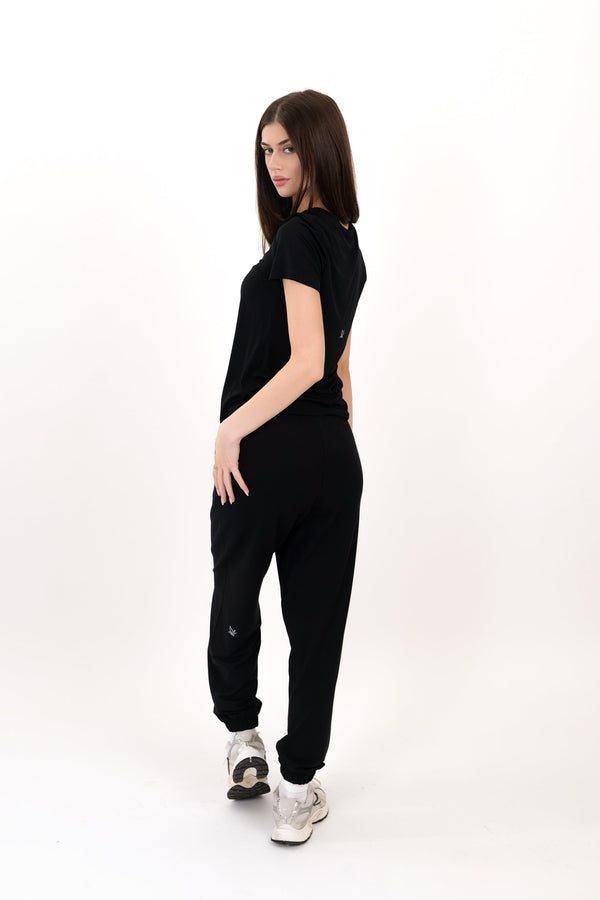 Model wearing The Solace Sweatpant in Onyx by ON/OFF Essentials, made from 95% bamboo fleece.