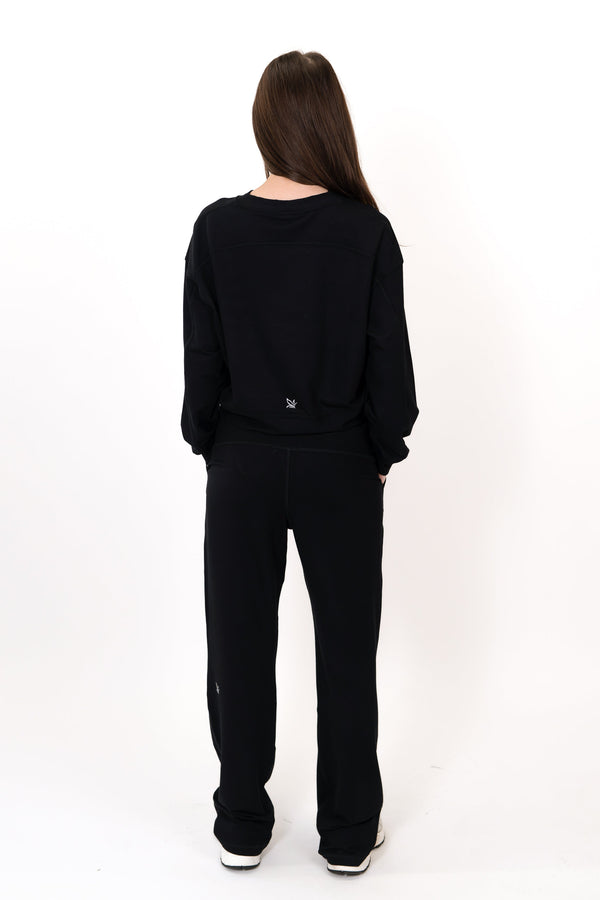 Model wearing The Solace Crew Neck in Onyx by ON/OFF Essentials, made from 95% bamboo fleece.